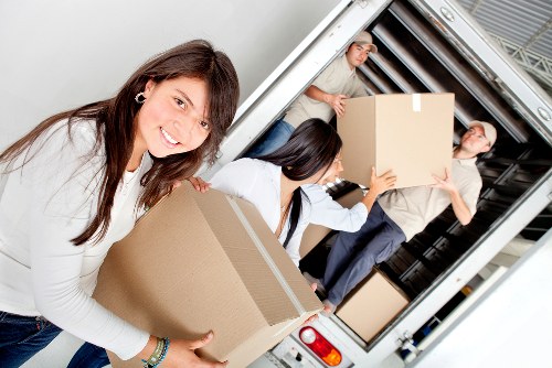Boxes and furniture being loaded into a removals van